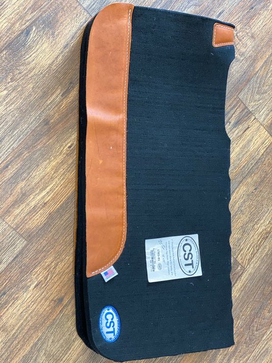 1 inch thick black felt pad with vent holes along the spine